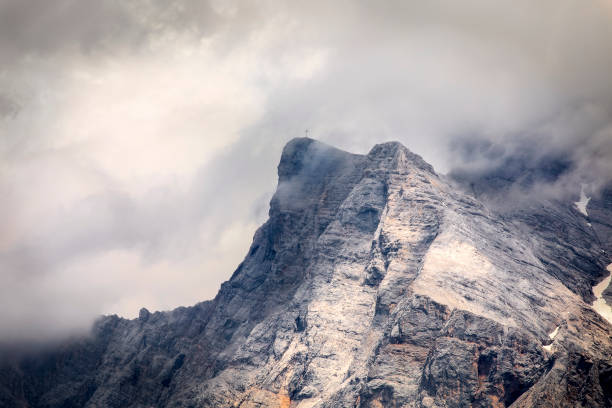 istock mountain rocky peak in clouds, Alps, Austria 1270499004