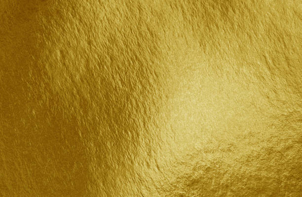 istock Gold foil background with highlights and uneven texture 1270499854