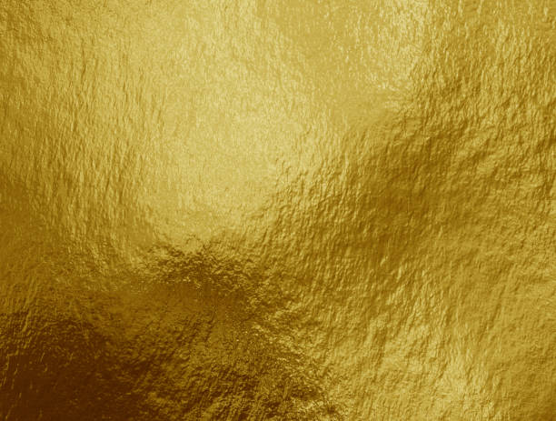 istock Gold foil background with highlights and uneven texture 1270499967