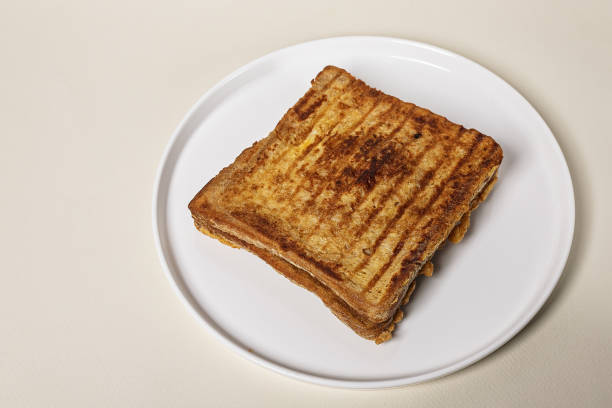 istock Sandwich with cheese on a round white plate on a beige background. Copy space. 1270502119