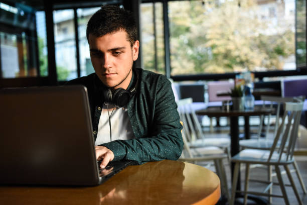 istock Young handsome man working on laptop at coffee shop 1270502217