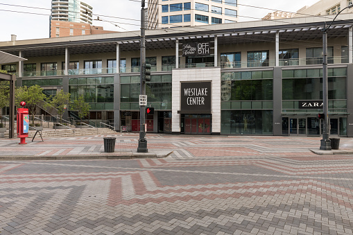 Seattle, USA – April 29, 2020: Late in the day an empty Westlake Shopping district with boarded up stores at the height of the Coronavirus city wide shut down.