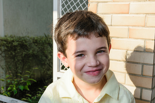 7 year old Brazilian child in a photo session at the nursery on a sunny afternoon.