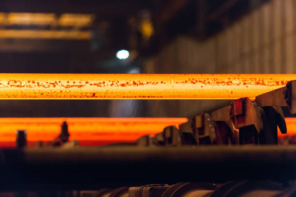 istock Hot square steel bloom on the roll-table. Huge ironworks. 1270503897