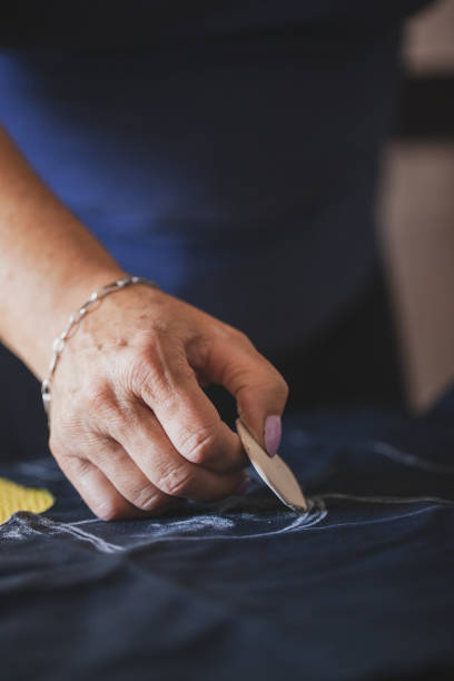 istock Tailor mature woman sewing at home 1270505789