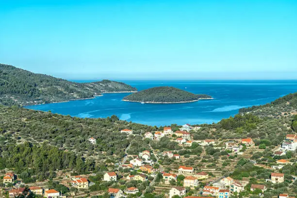Bay of Vela Luka on Korcula island aerial view on sunny day against blue sky.