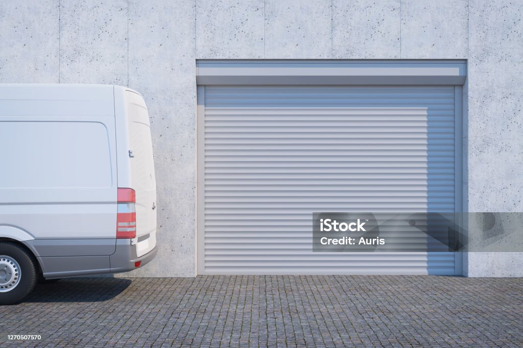 van near the  garage with closed shutter door Auto Repair Shop Stock Photo