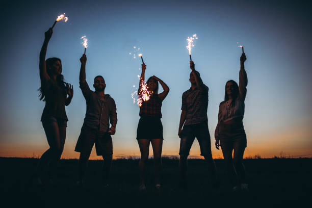 istock People holding torches high up at sunset 1270508979