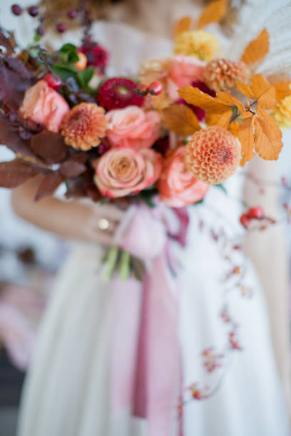 istock Bride with colorful autumn bouquet 1270509090