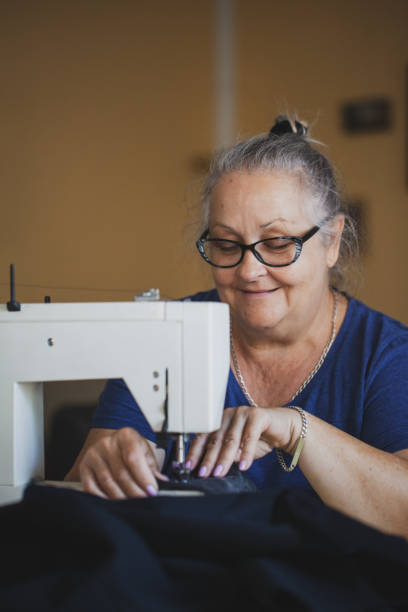 istock Tailor mature woman sewing at home 1270509107
