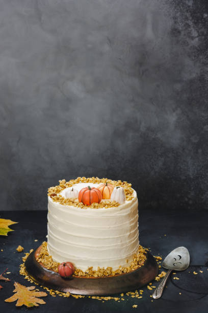 istock Pumpkin pie layer cake with brown sugar and  cream cheese frosting on rustic table  with autumnal decoration 1270509140