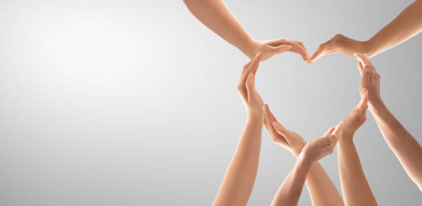 The concept of unity, cooperation, teamwork and charity. Symbol and shape of heart created from hands.The concept of unity, cooperation, partnership, teamwork and charity. diversity hands forming heart stock pictures, royalty-free photos & images