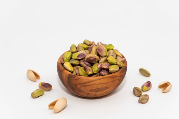 istock Pistachios nuts seed in a wooden bowl 1270510188