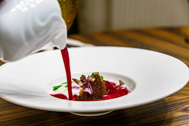 istock The waiter pours cold beetroot soup into a white plate 1270510892
