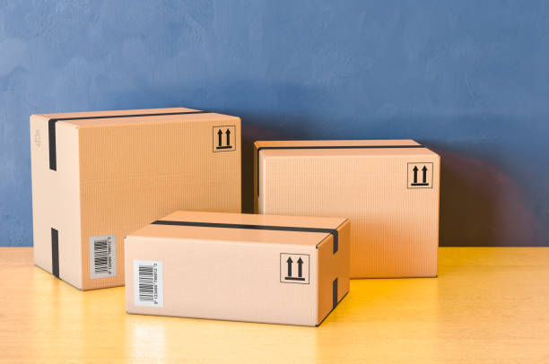 istock Three parcels. Shipping and logistics on the wooden table. 3D rendering 1270513813