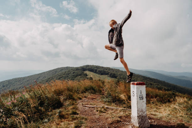 istock Boy jumping off a concrete post mimicking a leap of faith 1270515744