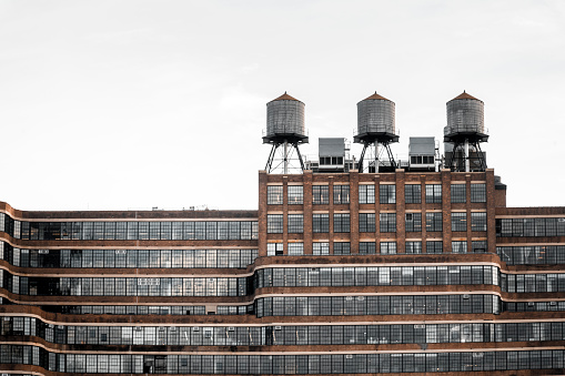 Rooftop water towers in Manhattan, New York City. This structure supplies water pressure to floors at higher elevation than public water towers.