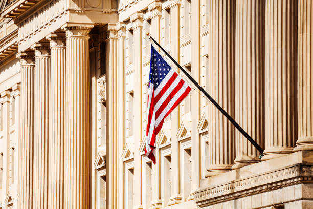 US flag over government building in Washington, DC US flag over classical government building with columns in Washington, DC baluster stock pictures, royalty-free photos & images