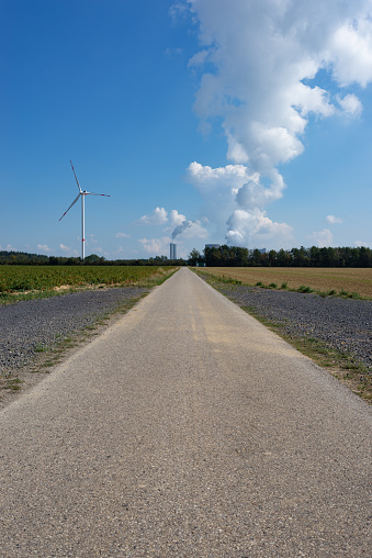 Wind turbines near Bergheim in Northrhine Westfalia with lignite-fired power plant Niederaussem in the background. Germany, September 2020