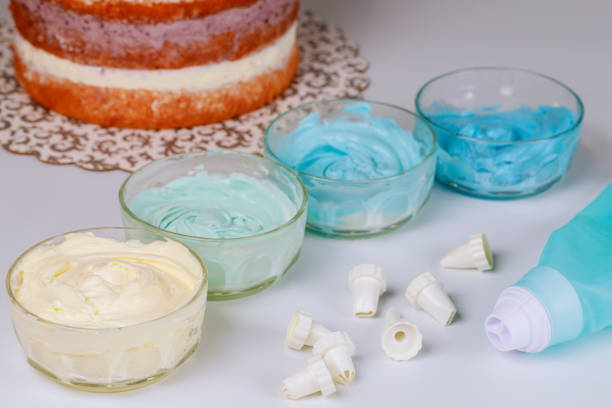 istock Cake decorating bag with nozzles and cream on white background. 1270539211