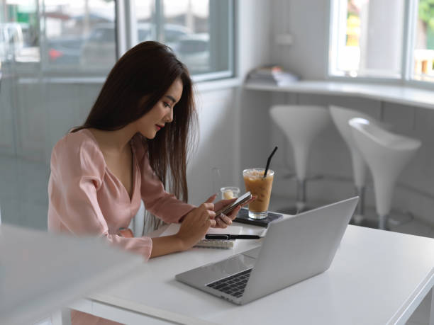 istock Young beautiful businesswoman using her smartphone while working in office room 1270547170