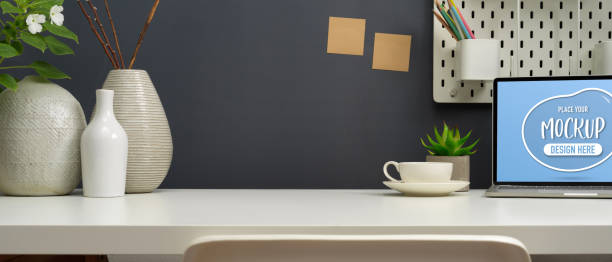 istock Close-up of modern workspace with mock up laptop computer and decorations 1270547970