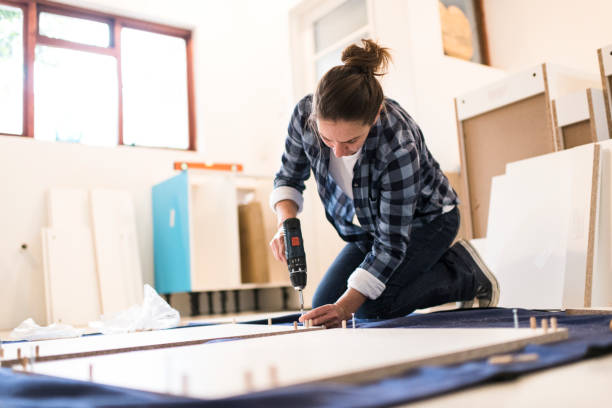 istock Low angle view of a woman using an electric screwdriver 1270549932