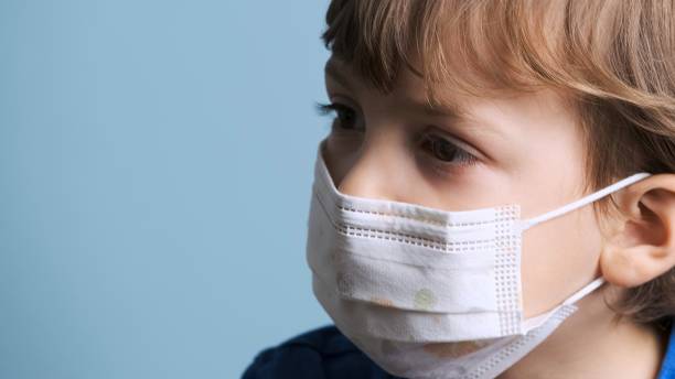 istock Serious Little child boy wearing a protective face mask 1270550062