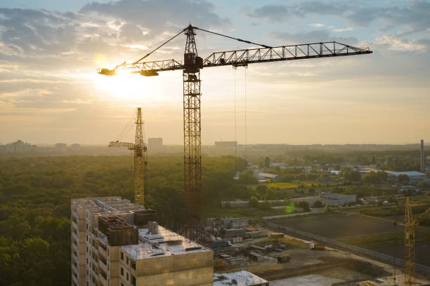 istock Beautiful view on tower cranes and building construction site at sunrise. 1270550107