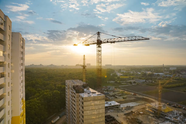istock Beautiful view on tower cranes and building construction site at sunrise. 1270550143