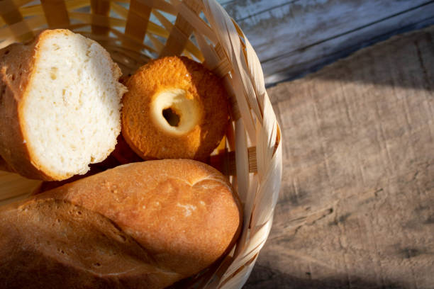 istock Fresh bread in a basket on a rough wooden table. Food background. 1270551265