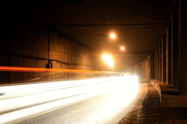 istock Old damp tunnel with water flowing from the wall. Tunnel with light trails. 1270551893