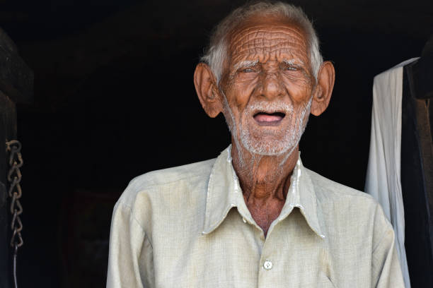 Happy Indian elderly man shows a communicating  gesture