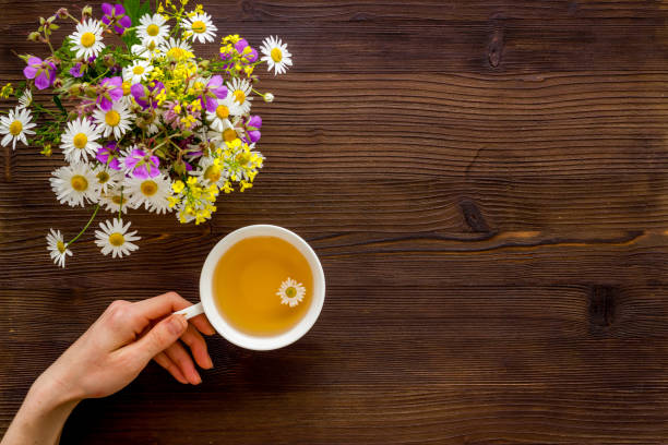 istock Wild flowers with herbal tea on a table top view, copy space 1270556384