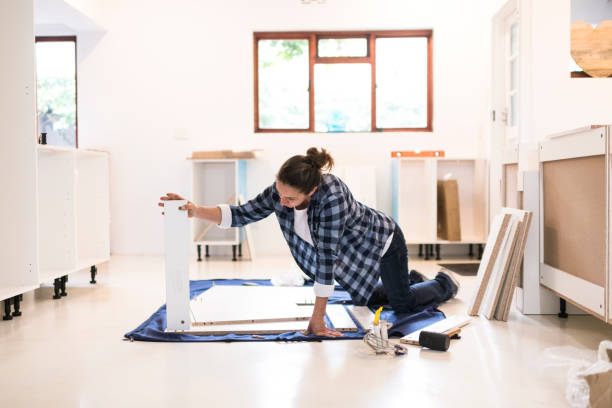 istock Female building kitchen cupboard placing parts 1270556413