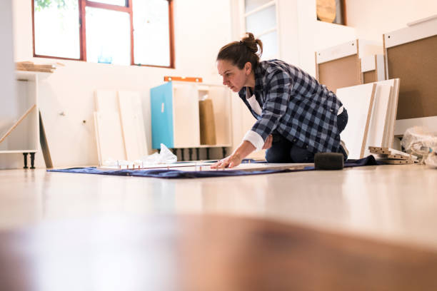 istock Low angle woman assembling new cabinets on kitchen floor 1270556415