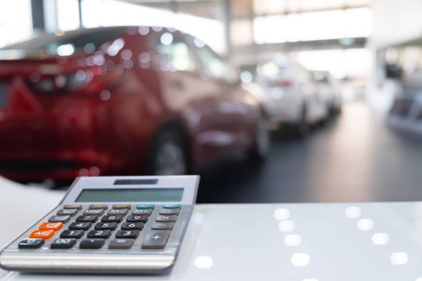 calculator for business finance on car showroom blurred bokeh background.for automotive automobile or transportation transport calculator for business finance on car showroom blurred bokeh background.for automotive automobile or transportation transport car dealership stock pictures, royalty-free photos & images