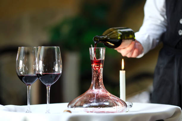istock A sommelier pouring red wine into decanter 1270557538