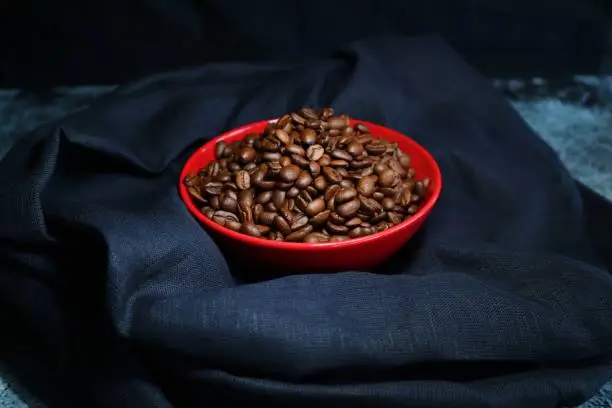 Coffee beans in a colorful ceramic bowl