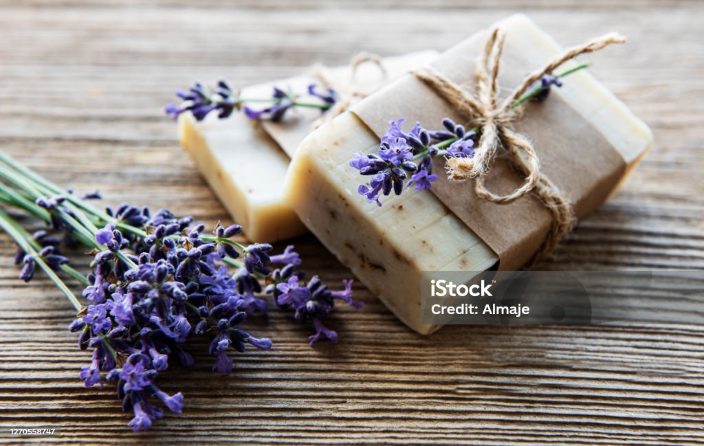 Bars of handmade soap with lavender Bars of handmade soap with lavender flowers over  wood grunge background. Soap Stock Photo