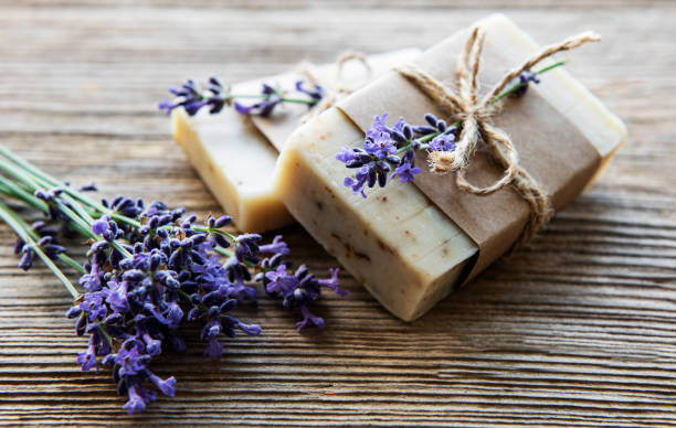 Bars of handmade soap with lavender Bars of handmade soap with lavender flowers over  wood grunge background. home made stock pictures, royalty-free photos & images