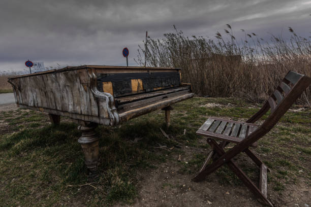 istock old piano with a chair on a meadow 1270561690