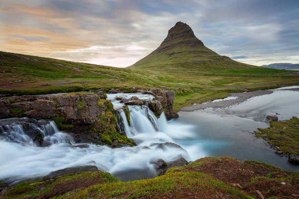 Kirkjufellsfoss Iceland Amazing sunset the top of Kirkjufellsfoss waterfall with Kirkjufell mountain in the background on the north coast of Iceland's Snaefellsnes peninsula taken white a long shutter speed. kirkjufell stock pictures, royalty-free photos & images