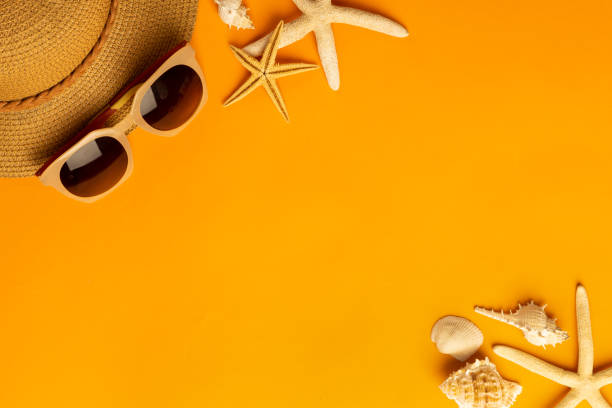 istock Summer background with beach accessories - straw hat, sunglasses on vibrant orange background top view with copy space 1270561797