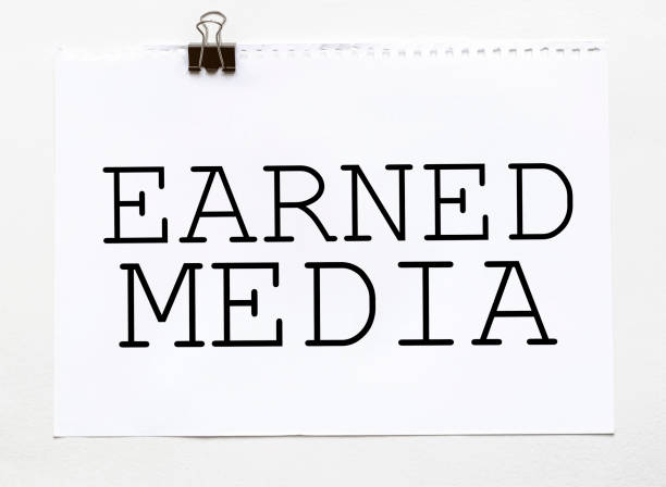 istock white paper with text Earned Media on a white background with stationery 1270564626