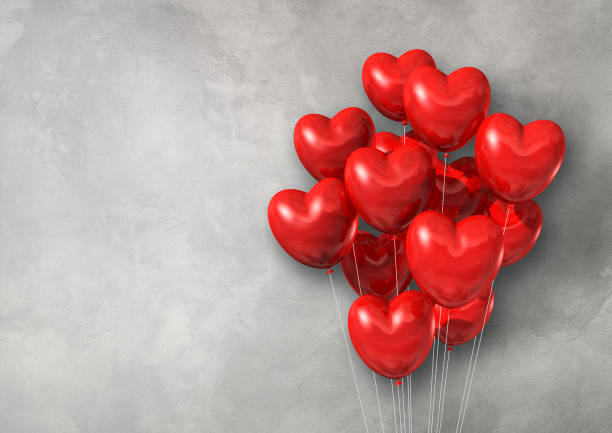 istock Red heart shape air balloons group on a concrete wall banner 1270565526