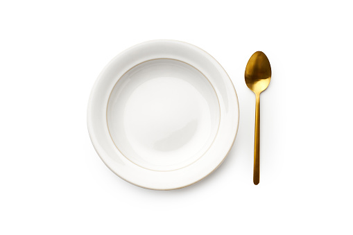 Flat lay white empty plate and golden spoon isolated on white background. Top view with copy space