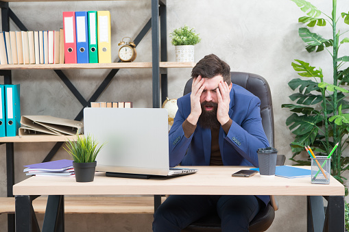 Unforgivable mistake. Falling stock prices. Man bearded boss sit office with laptop. Manager solving business problems online. Business man failed. Risky business. Broker and financial indicators.