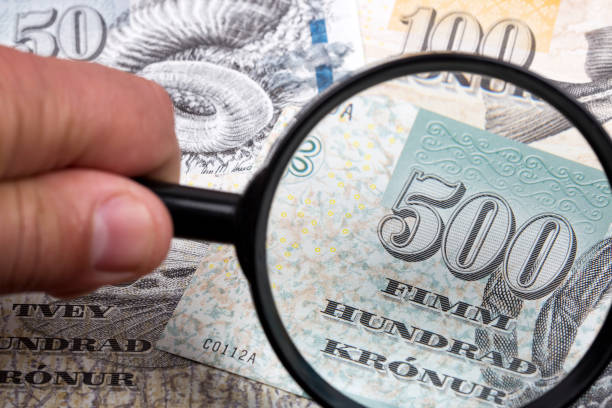 istock Money from the Faroe Islands in a magnifying glass 1270568954