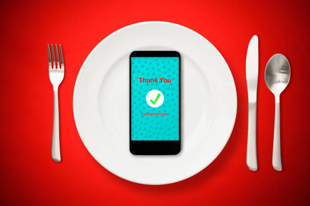 Overhead shot of cashless payment using a smartphone with Christmas meals.